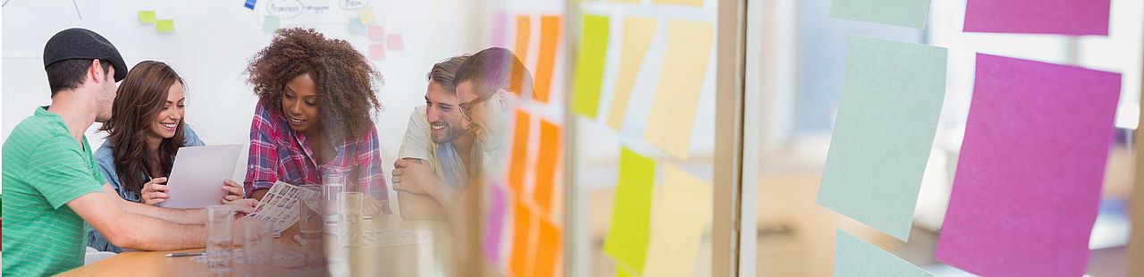 Millennial creative team around table and sticky note transition