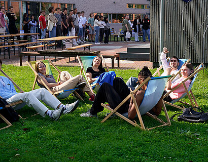 Studierende in Liegestühlen auf der Campuswiese der TH Wildau