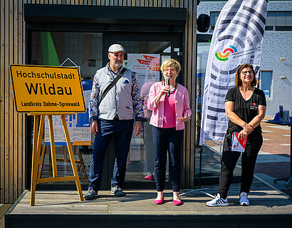 TH-Wildau-Präsidentin Prof. Ulrike Tippe, Wildaus Bürgermeister Frank Nerlich und Susanne Trotzki, Moderatorin von radioSKW, bei der Eröffnung des HIT 2024 vor der ScienceBox der TH Wildau.